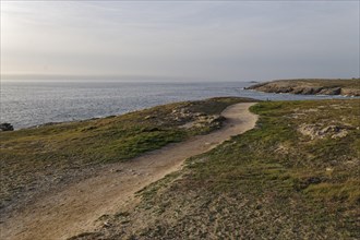 Hiking trail on the Cote Sauvage. The Wild Coast is a rocky coast on the west side of the Quiberon Peninsula in Brittany. Cores