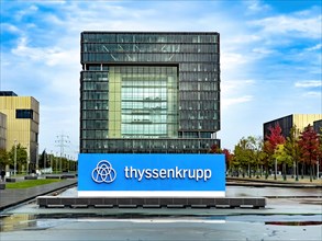 View of headquarters in the background in the form of cube of steel giant company of steel production manufacturer of steel thyssenkrupp Thyssen Krupp in the foreground logo and lettering
