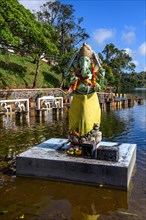 Hindu god Hindu deity God figure Statue in elephant shape Shape of elephant Elephant god Ganesha stands on pedestal in Sacred lake religious site largest Hindu sanctuary Sanctuary for religion Hinduis...