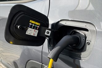 Grey eco-friendly e-car electric powered car vehicle brand Alfa Romeo is charged with e-plug type 2 plug type 2 plug Mennekes standard for Europe