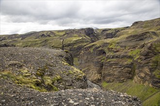 A young man on a cliff in the Landmannalaugar valley on the trek. Iceland