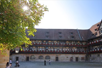 Inner courtyard of the Alte Hofhaltung built 15th century with floral decoration in the backlight