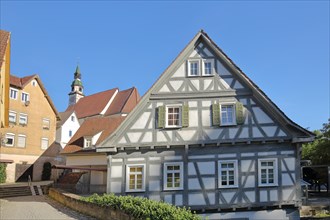 Half-timbered house Buergermuehle and church tower