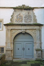Gate with coat of arms in the courtyard of the Romanesque Comburg monastery