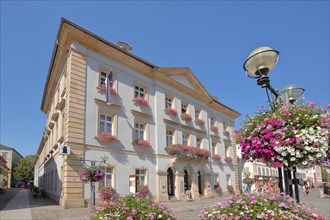 Town hall with flower decoration and street lamp