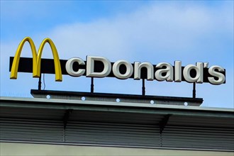 Logo yellow M in with lettering McDonald's above fast food restaurant