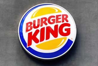 Logo and advertising on wall of building for fast food chain Burger King