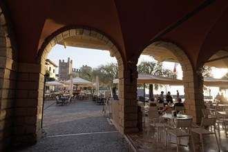 View through arcades of Piazza Calderiini and Scaliger Castle