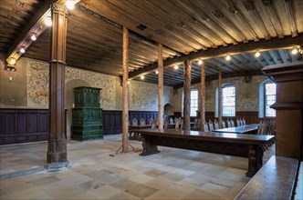 Interior view of winter refectory with tiled stove