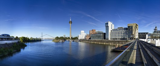 Duesseldorf Media Harbour with the Rheinturm television tower and the Gehry buildings towards evening