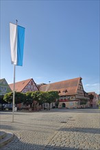 Market place with Bavarian flag and half-timbered house