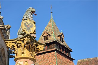 Detail of lion fountain built 1773 and historic Romanesque bell tower built 1228