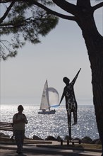 Lakeside promenade with metal sculpture by Ettore Peroni