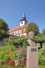 Monument to historian Josef Hemmerle and Holy Trinity Church