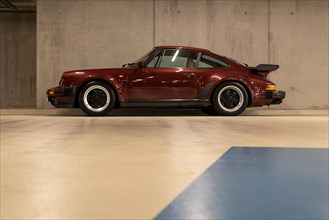 Wine-red Porsche in an underground car park