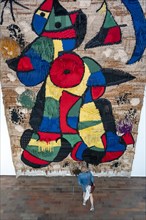 Visitor in front of a tapestry at Joan Miro Foundation