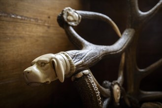 Armrest with carved dog's head