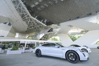 Porsche cars parked in front of the Porsche Museum