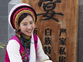Young laughing Chinese woman in traditional festival dress