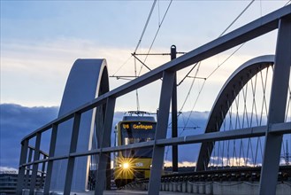 Network arch bridge over the A8 motorway. Light rail bridge of the SSB for the U6 airport line. The span of the arches is 80 metres. Tension elements made of carbon. The U6 line light rail bridge rece...