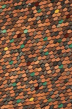 Roof with colourful roof tiles from the bell tower