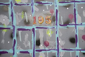 Colourfully painted house wall with house number 195