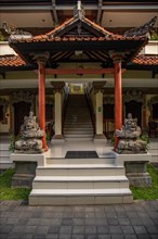 Park with tropical plants and traditional statues of the Hindu faith and for decoration. Tropical island life as a tourist on Bali