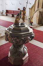 Baptismal font in the late Gothic church of St. John the Baptist