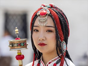Tibetan young woman with festive hair ornaments