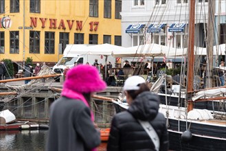 Tourists standing in front of the colourful houses in Nyhavn