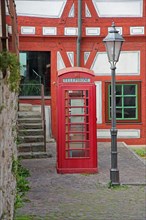 Old red telephone box and street lamp