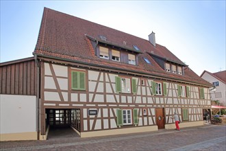 Brown half-timbered house with green shutters