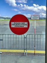 Round red prohibition sign on glass door Access only for authorised persons behind it sign with warning Notice Prohibition Attention Air Traffic Control Area Unauthorised persons are not allowed to en...