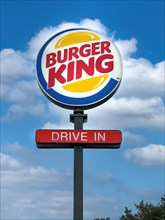 Logo and advertisement for the fast food chain Burger King with the words Drive In below