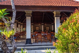 Park with tropical plants and traditional statues of the Hindu faith and for decoration. Tropical island life as a tourist on Bali