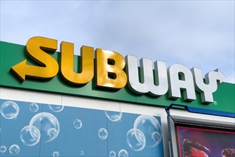 Yellow white lettering logo Subway over restaurant fast food restaurant of fast food chain