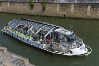 Excursion boat with glass roof on the Seine