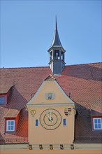 Roof with spire and clock of the town hall built 1477