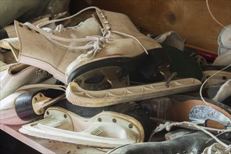 Vintage woman's and men's ice skates for sale inside second hand goods and chattels store