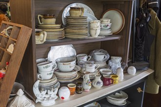 Porcelain and ceramic dishes and cups for sale inside second hand goods and chattels store