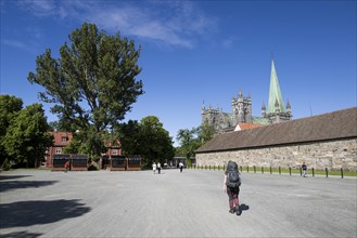 Pilgrim with backpack approaching Nidaros Cathedral