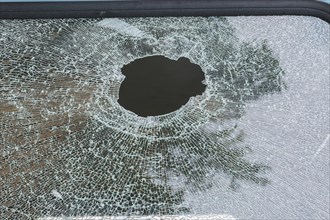 Hole in shattered side window of mini-van