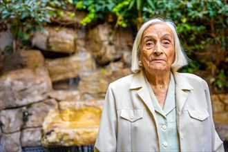 Portrait of an elder woman in the garden of a nursing home