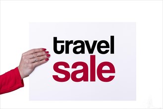 Woman hand holding a TRAVEL SALE white poster on transparent background. Studio shot. Commercial concept