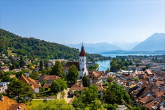 Aerial View over City of Thun with Church Tower and Lake Thun with Mountain Range in a Sunny Summer Day in Bernese Oberland