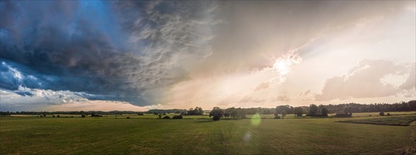 Summer landscape with majestic clouds after thunderstorm