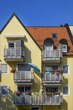 Yellow facade with green balconies