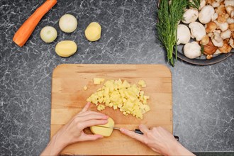 Close up overhead view of female hands while cooking in kitchen