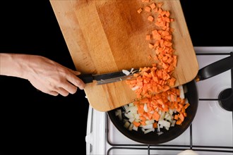 Put chopped onion and carrot on a frying pan