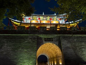 Old Chinese city gate with illuminated roofs